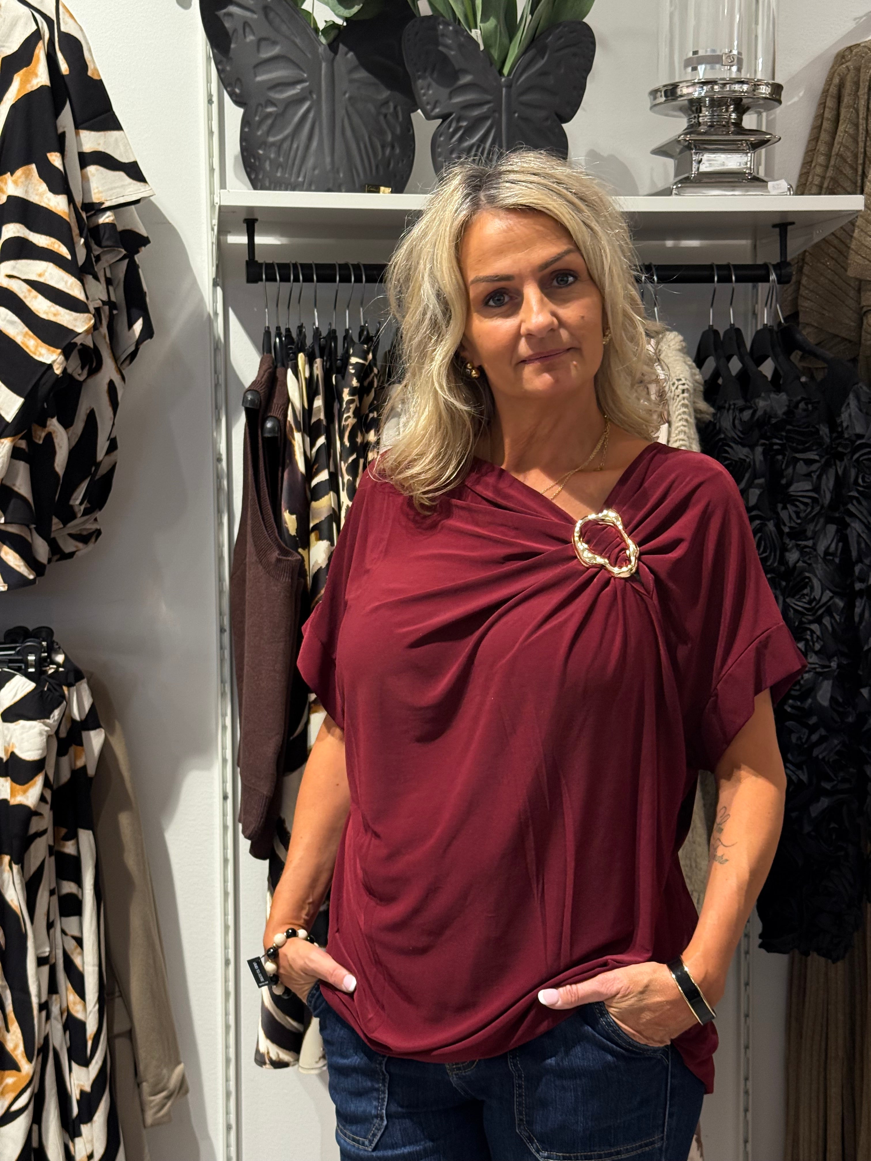 Top with gold jewelry, burgundy red